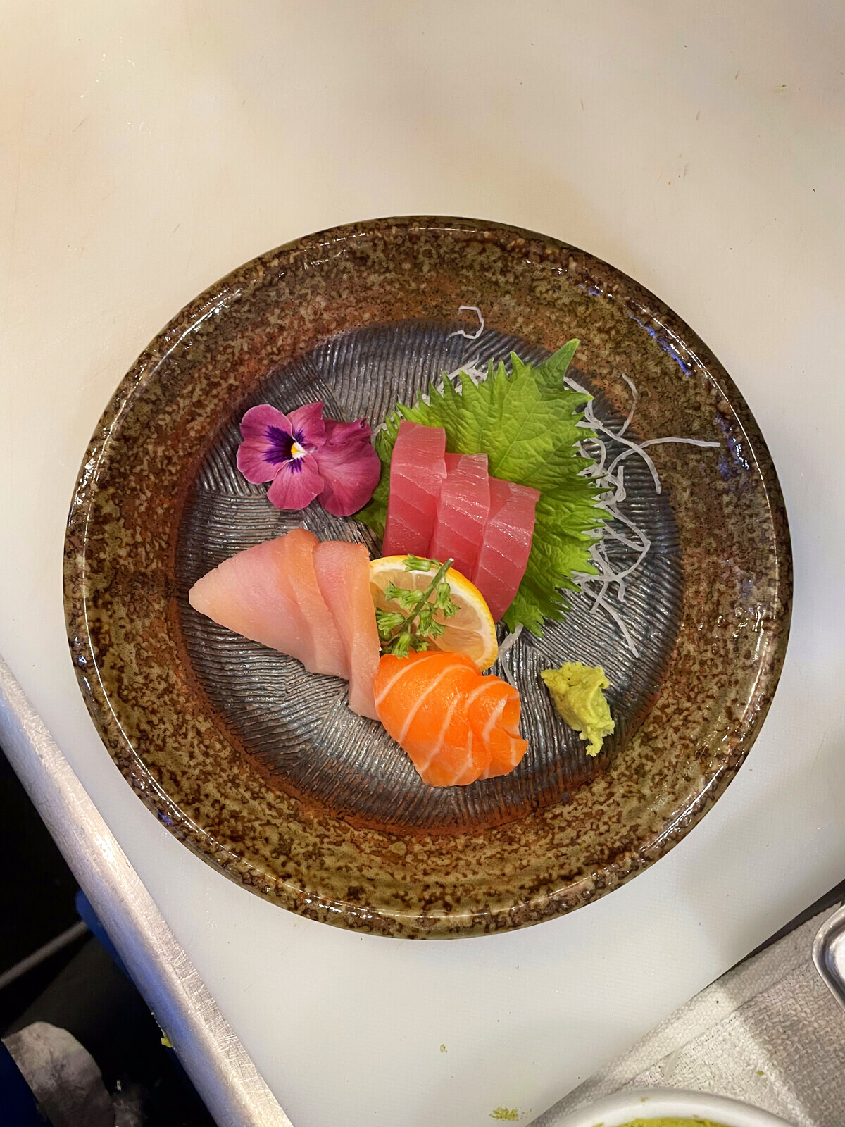 Omakase sashimi course with tuna, salmon, and yellowtail